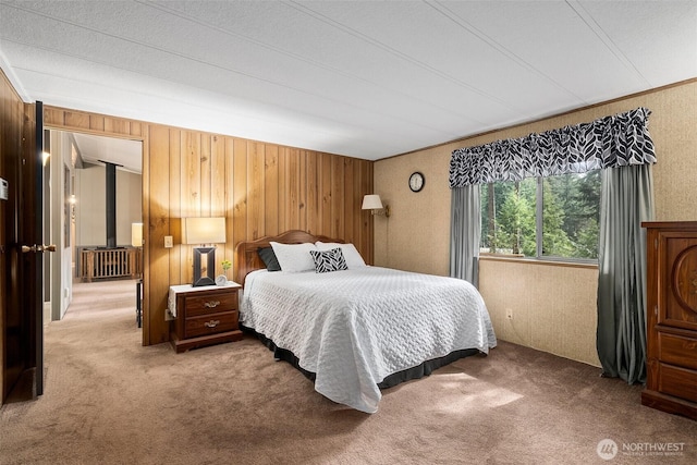 bedroom with wood walls and carpet floors