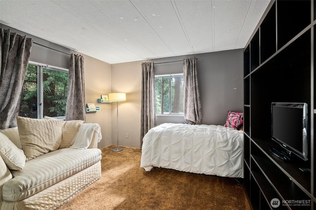 bedroom featuring a textured ceiling and carpet flooring