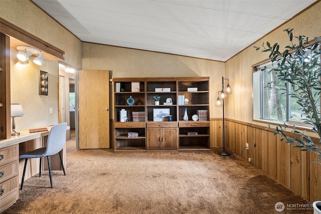 carpeted office featuring a wainscoted wall, wood walls, built in study area, and vaulted ceiling