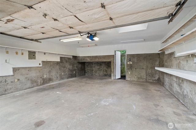 garage with electric panel and a garage door opener