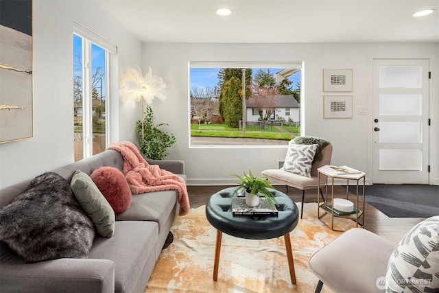 living room with a wealth of natural light, recessed lighting, and wood finished floors