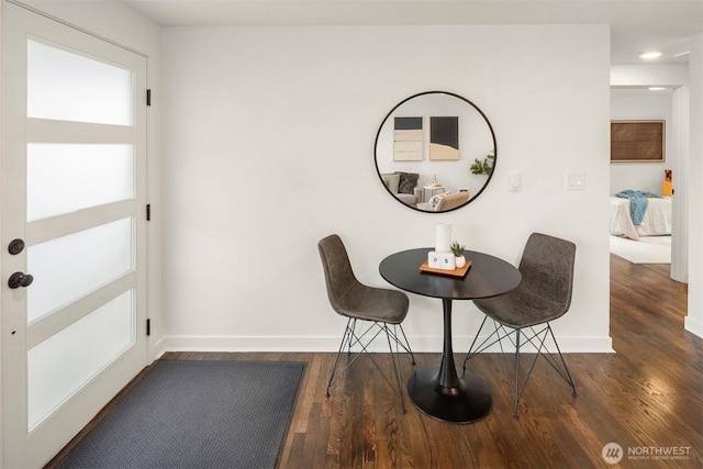 dining room featuring baseboards and wood finished floors