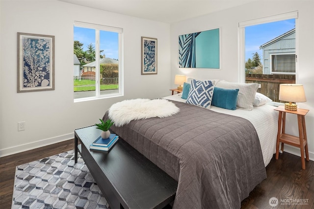 bedroom featuring baseboards and wood finished floors