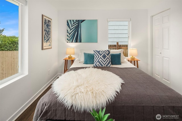 bedroom with baseboards and wood finished floors