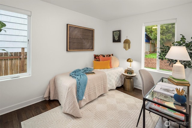 bedroom with wood finished floors and baseboards