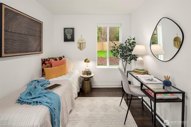 bedroom featuring baseboards and wood finished floors