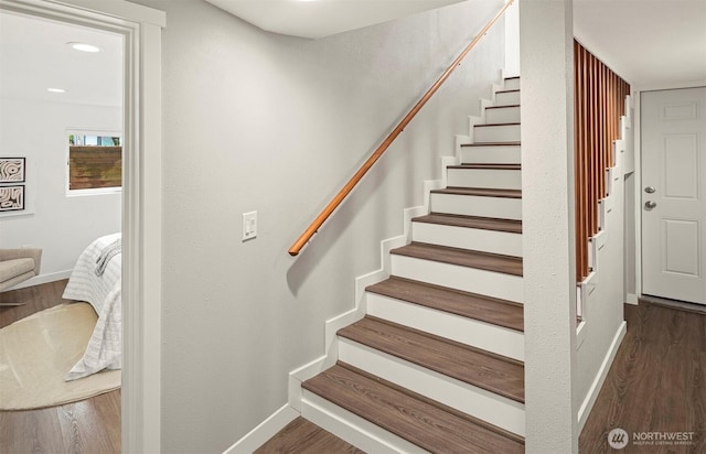 staircase featuring recessed lighting, wood finished floors, and baseboards