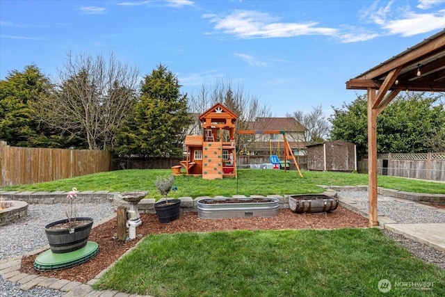 view of yard with a storage shed, an outbuilding, a playground, and a fenced backyard