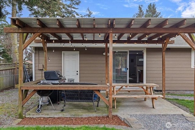 rear view of house featuring a patio area, fence, and a pergola