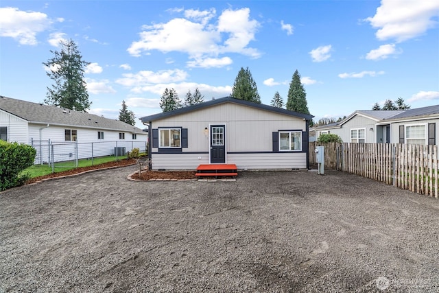 view of front of house featuring crawl space, cooling unit, fence private yard, and driveway