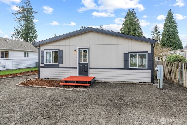 view of front facade featuring fence and crawl space