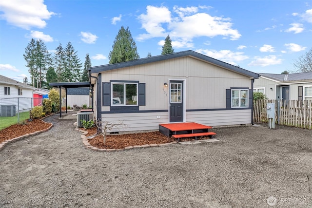 view of front of property with crawl space, cooling unit, and fence