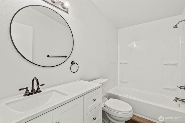 full bath with shower / bathtub combination, toilet, wood finished floors, and vanity