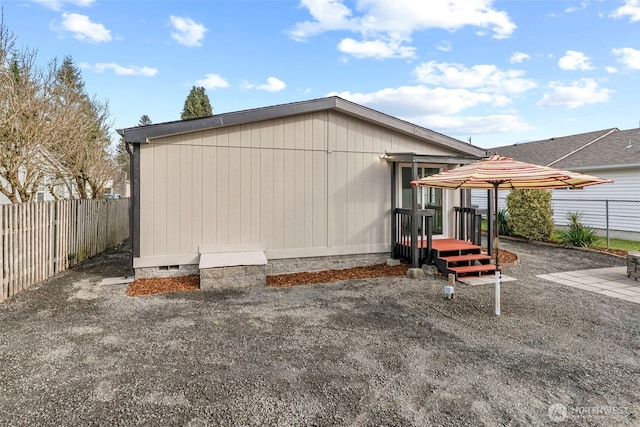 back of property featuring crawl space, a patio area, and a fenced backyard