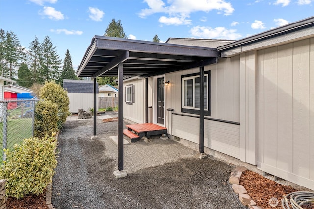 view of patio / terrace featuring an outbuilding, a shed, and fence