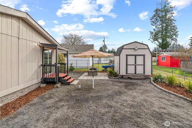 view of yard featuring a patio area, fence, an outdoor structure, and a shed