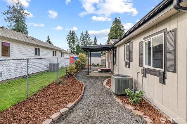 view of yard featuring a fenced backyard, a patio area, and central AC