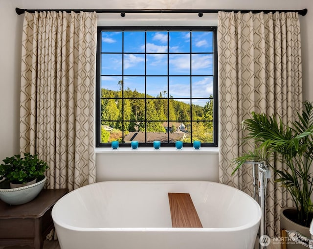 full bath featuring a soaking tub