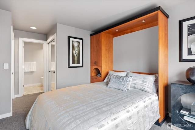 carpeted bedroom featuring recessed lighting, baseboards, and ensuite bathroom