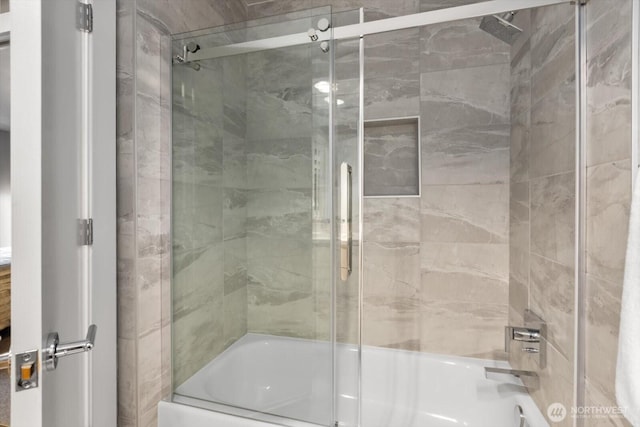 full bath featuring shower / bath combination with glass door