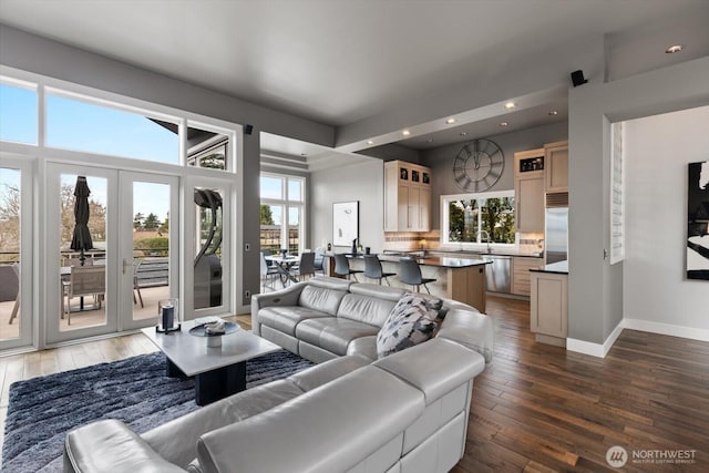 living room with hardwood / wood-style floors, recessed lighting, and baseboards