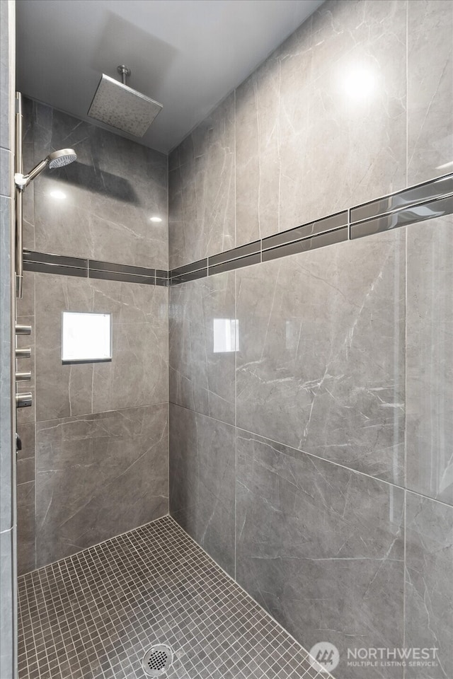 full bathroom with tiled shower