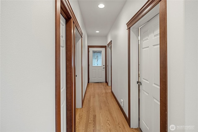 corridor with recessed lighting, baseboards, and light wood-style floors