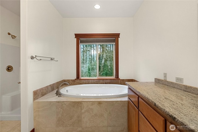 bathroom with tile patterned floors, walk in shower, and a garden tub