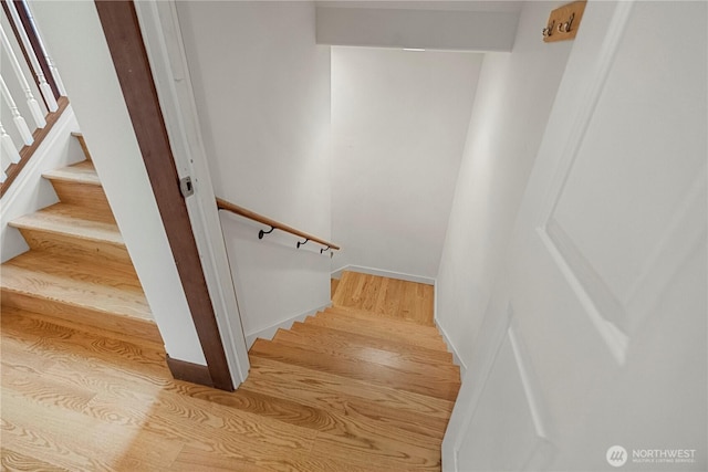 stairway featuring wood finished floors and baseboards