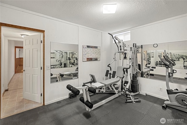 workout area featuring a textured ceiling