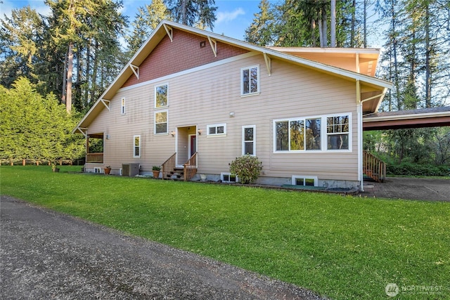 15809 Spanaway Loop Rd S, Spanaway, WA 98387 - view of front of home with a front yard, entry steps, an attached carport, and cooling unit