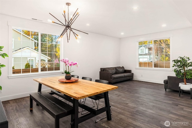 dining area featuring visible vents, dark wood-type flooring, baseboards, recessed lighting, and a notable chandelier