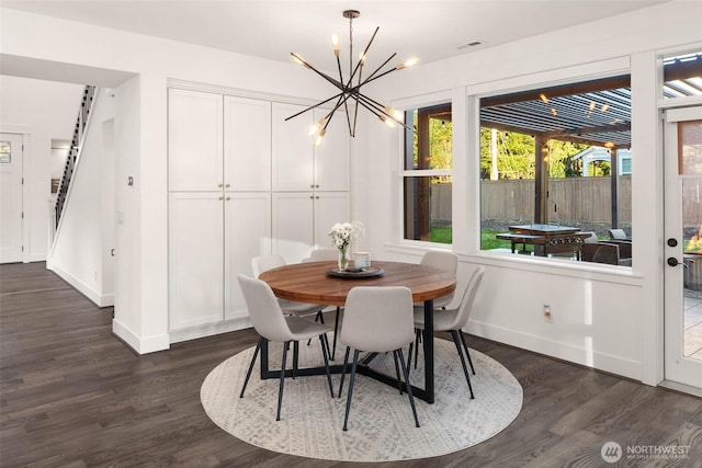 dining area with stairway, baseboards, visible vents, dark wood-type flooring, and a chandelier