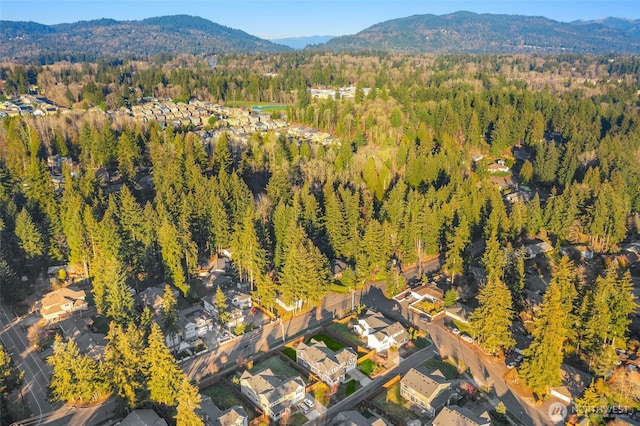 bird's eye view with a mountain view and a forest view