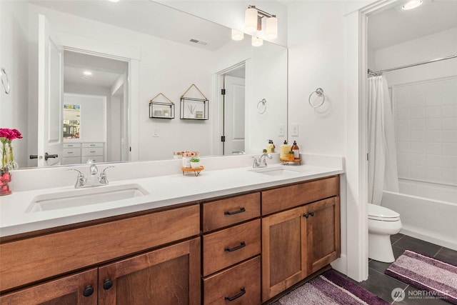 full bathroom with a sink, visible vents, double vanity, and tile patterned flooring