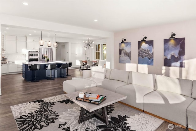 living room featuring recessed lighting, a chandelier, and dark wood finished floors