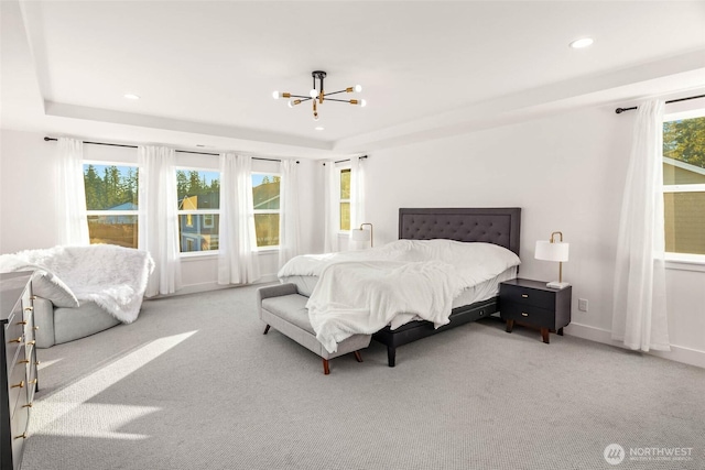 bedroom featuring multiple windows, carpet, and a chandelier