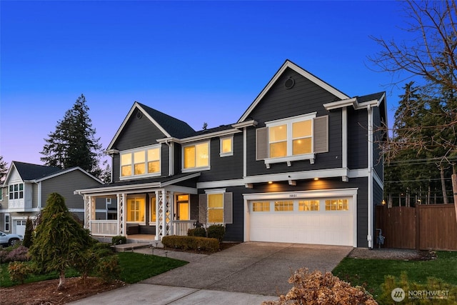 view of front of house featuring a garage, a porch, driveway, and fence