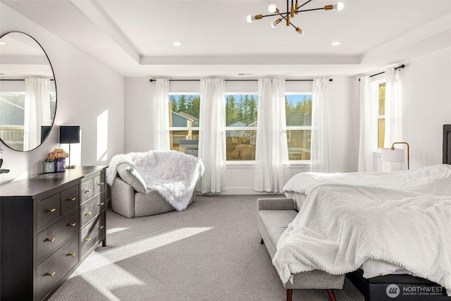 bedroom with recessed lighting, an inviting chandelier, a raised ceiling, and carpet