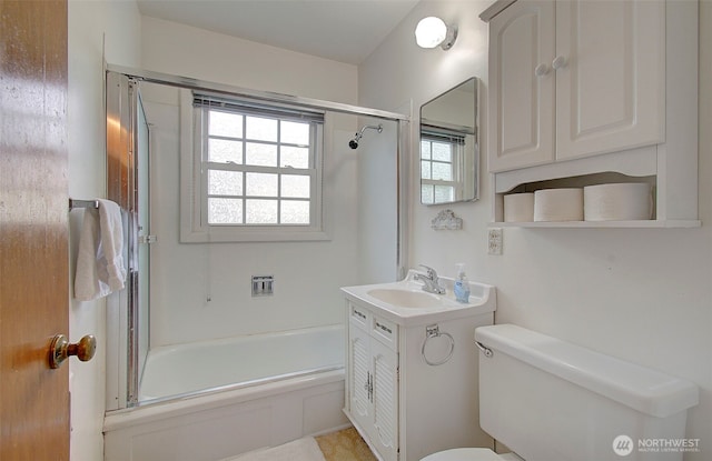 full bathroom with combined bath / shower with glass door, toilet, and vanity