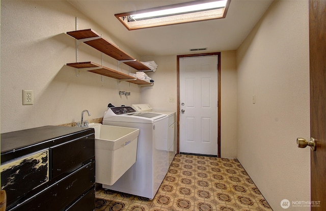 clothes washing area featuring washer and clothes dryer, laundry area, and visible vents