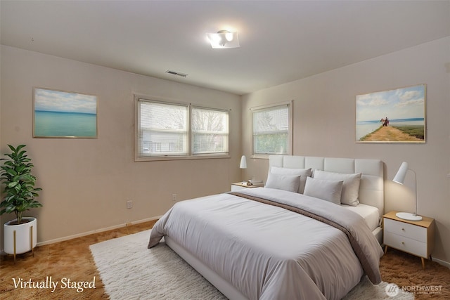 carpeted bedroom featuring visible vents and baseboards