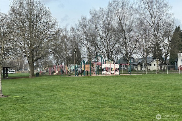 surrounding community featuring fence, a lawn, and playground community