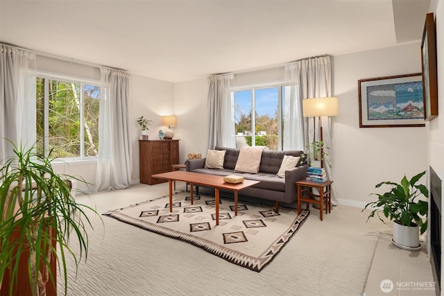 carpeted living room featuring plenty of natural light and baseboards