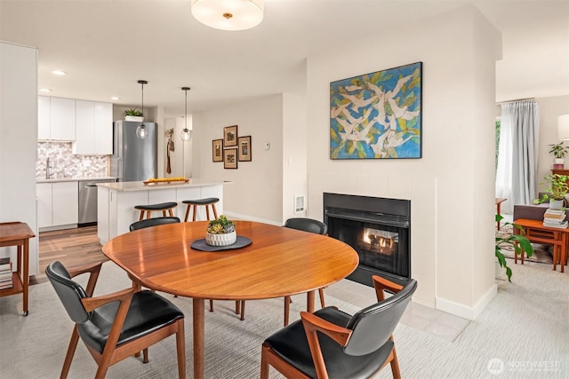 dining area featuring recessed lighting, baseboards, and a fireplace