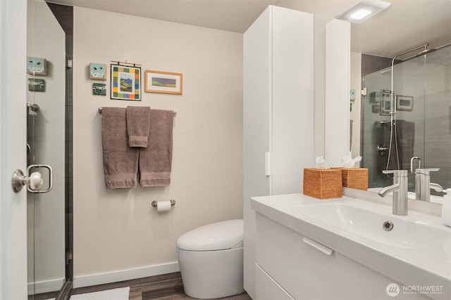 bathroom featuring baseboards, toilet, a stall shower, and vanity