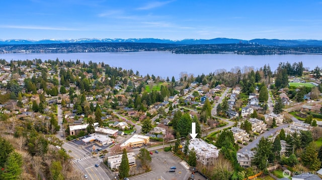 birds eye view of property with a water and mountain view