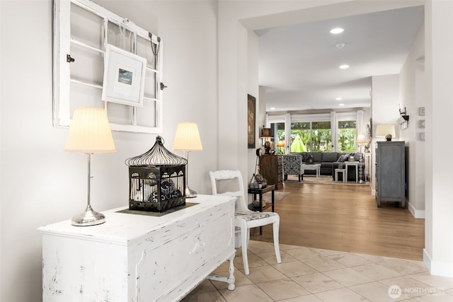 living area featuring light tile patterned flooring, recessed lighting, and baseboards