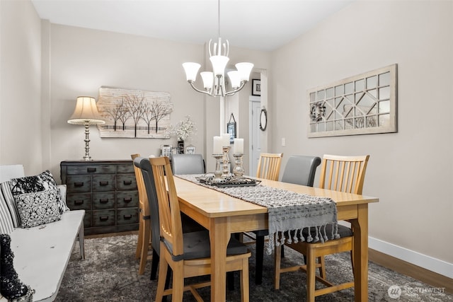 dining room featuring baseboards, an inviting chandelier, and wood finished floors