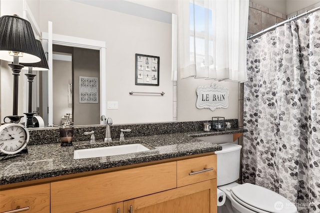 bathroom with vanity, a shower with shower curtain, and toilet